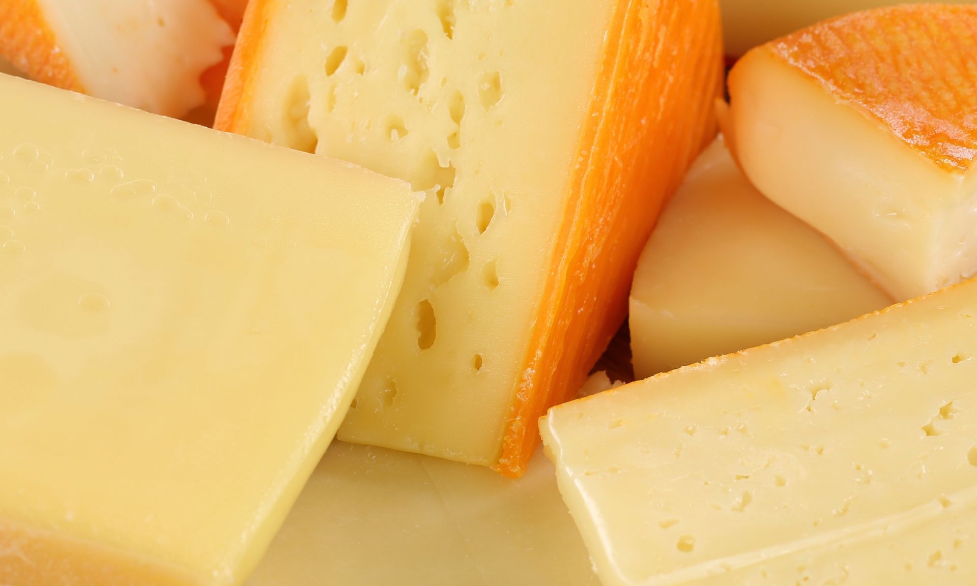 Er liggen veel verschillende soorten kaas op het bord.