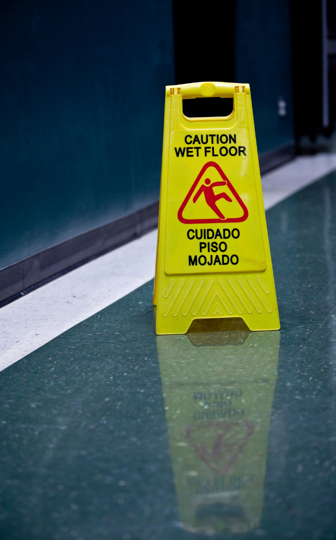 A yellow caution wet floor sign is on the floor.