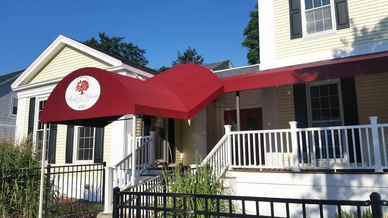 A house with a red awning over the front porch