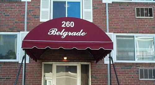 A brick building with a red awning that says belgrade