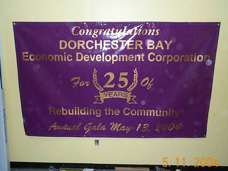 A purple sign that says congratulations dorchester bay economic development corporation