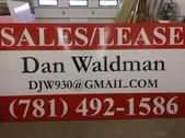 A red and white sales and lease sign for dan waldman.