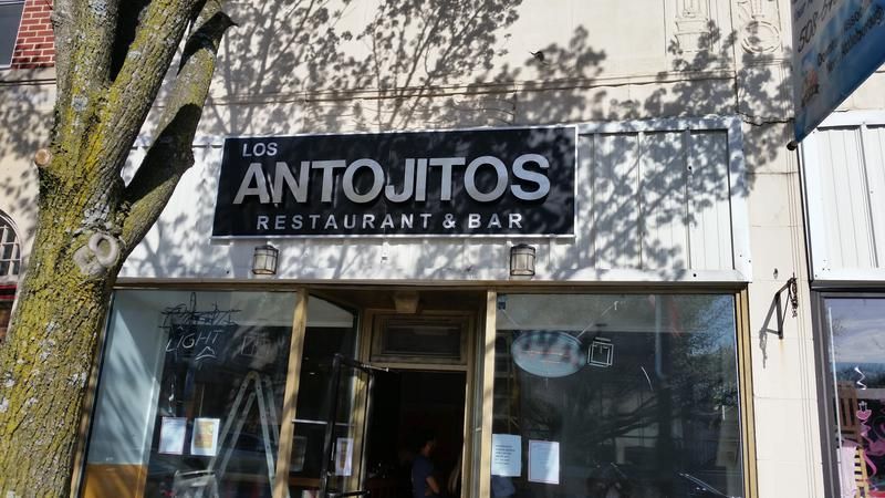 A restaurant with a sign that says antojitos restaurant & bar