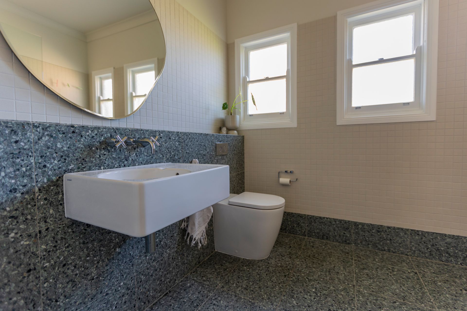 bathroom with floating sink and toilet