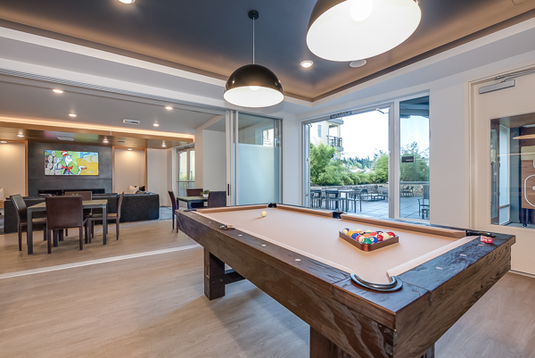 Photo of the pool table, and a sports lounge type of area in the background
