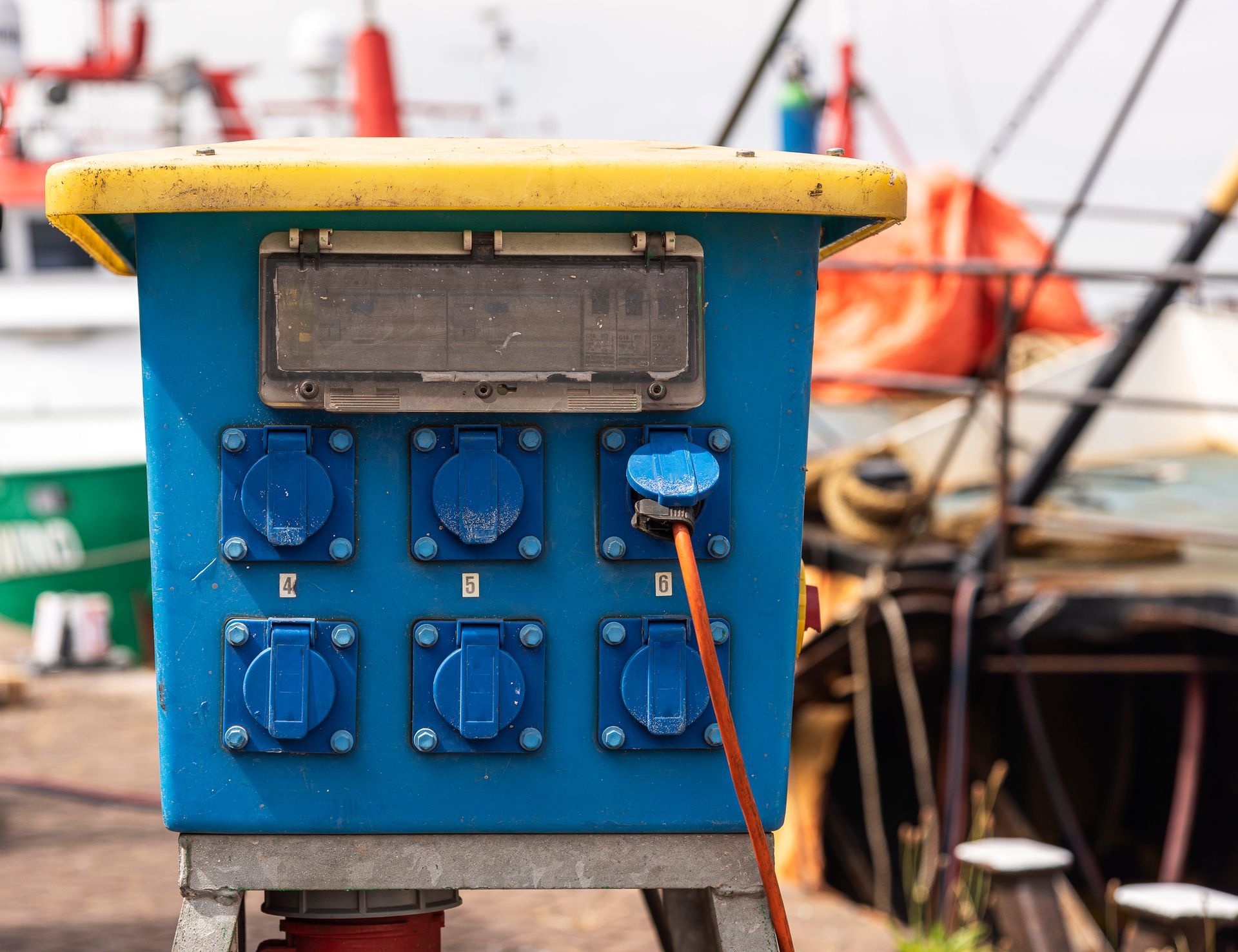 A blue and yellow box with electrical outlets on it.