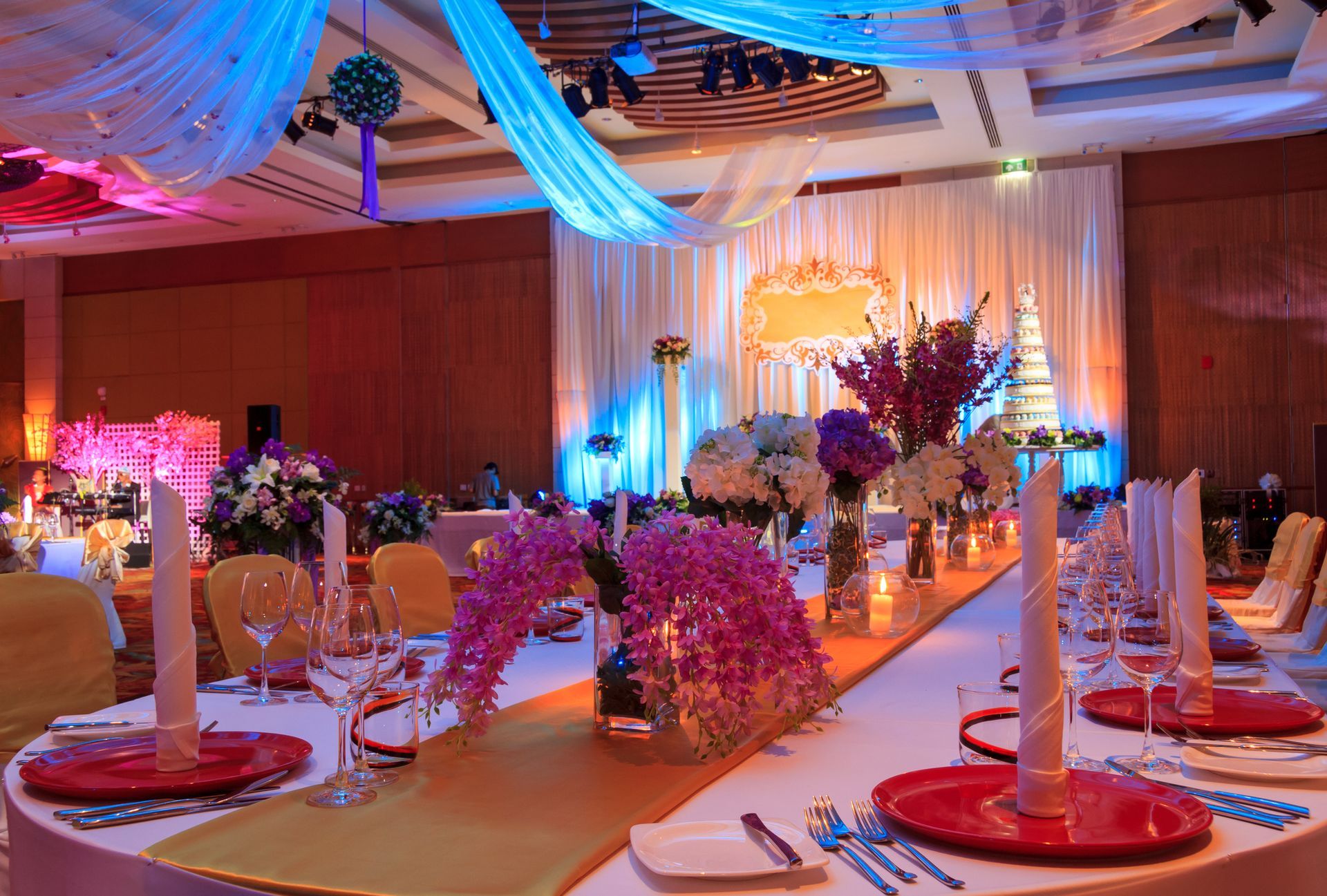 A large room with tables and chairs set up for a wedding reception.