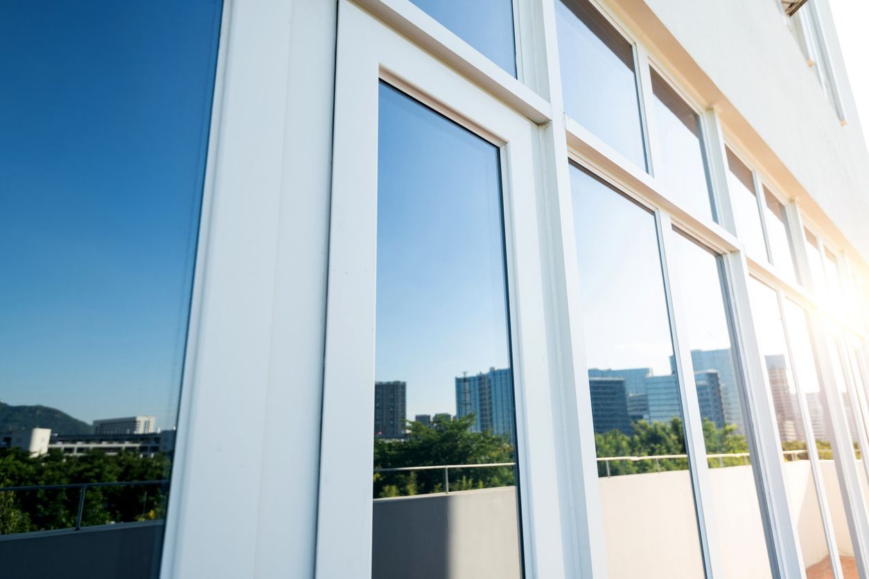 The sun is reflected in the windows of a building.