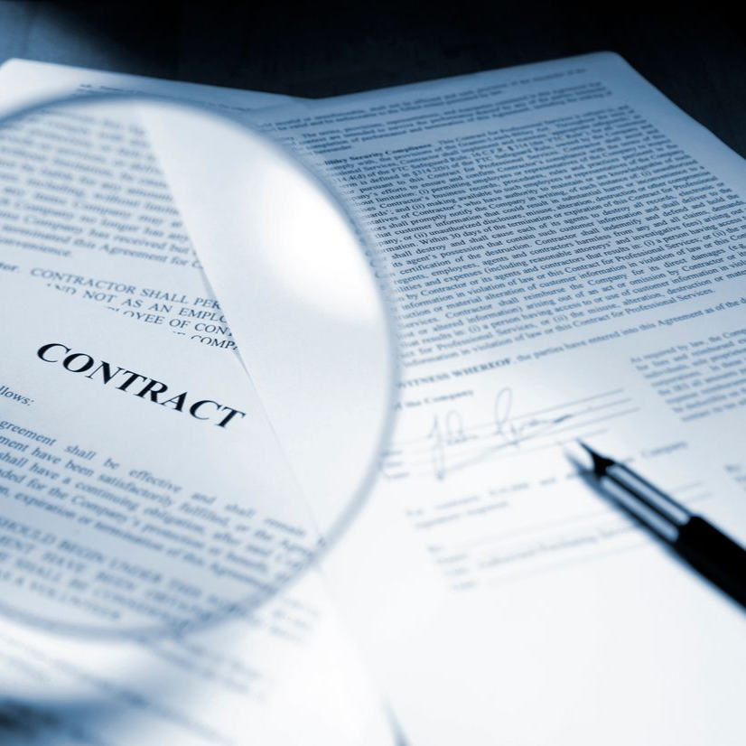 Three workers in orange vests walk through a warehouse carrying equipment; one smiles.
