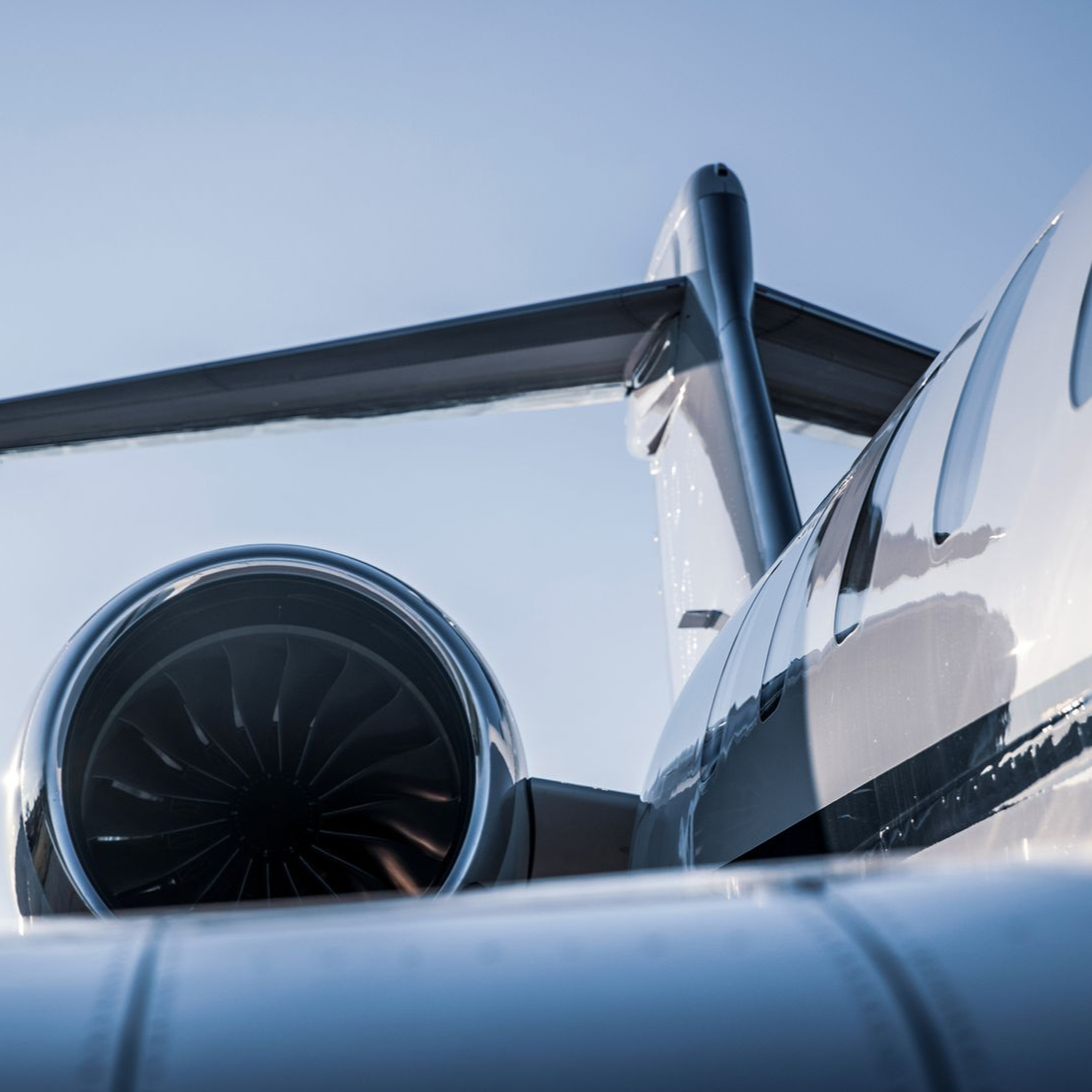 Airplane being towed by a white tug vehicle on an airport tarmac.