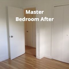 A living room with a couch , chairs , ottoman and a mirror