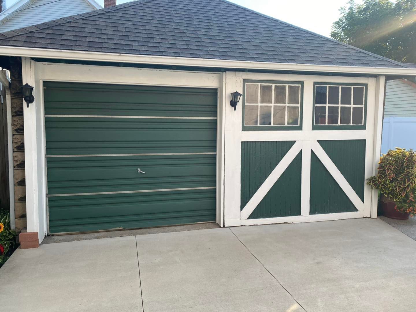 Green garage door with white trim, and matching green door with white accent.