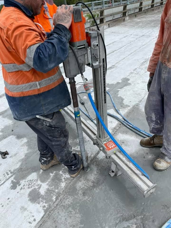 A man is using a machine to cut concrete. — Newcastle Cut N Drill Pty Ltd In Boolaroo, NSW