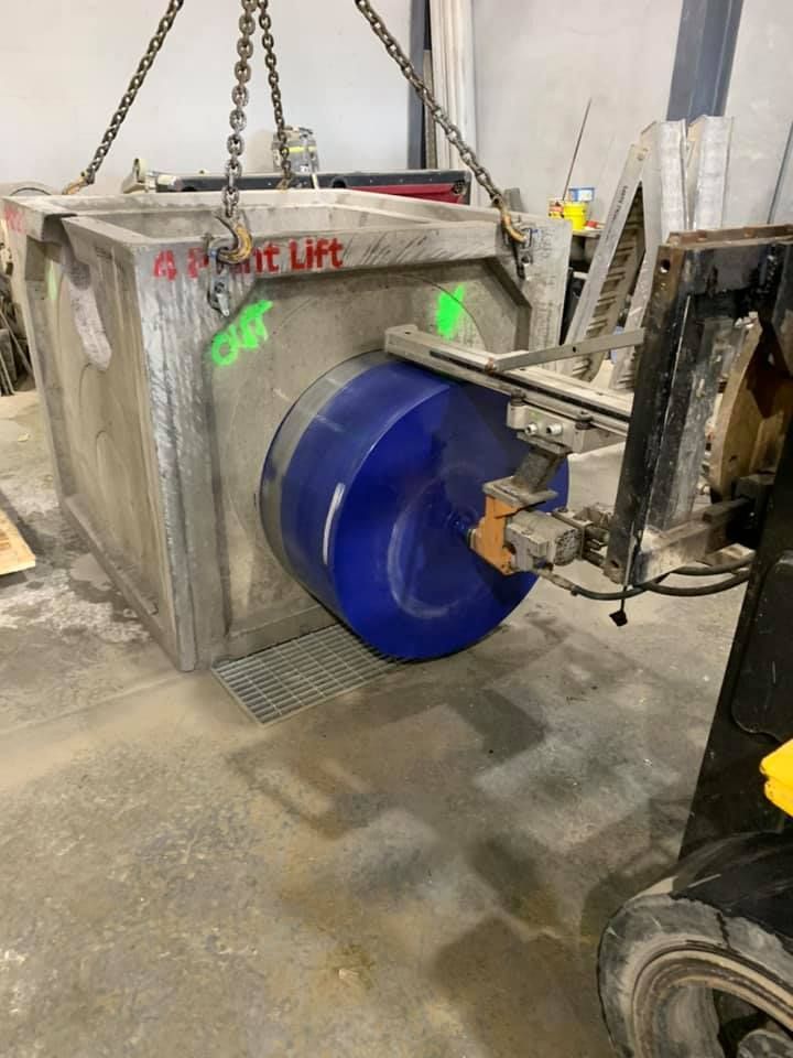 A large blue barrel is being lifted by a forklift. — Newcastle Cut N Drill Pty Ltd In Boolaroo, NSW