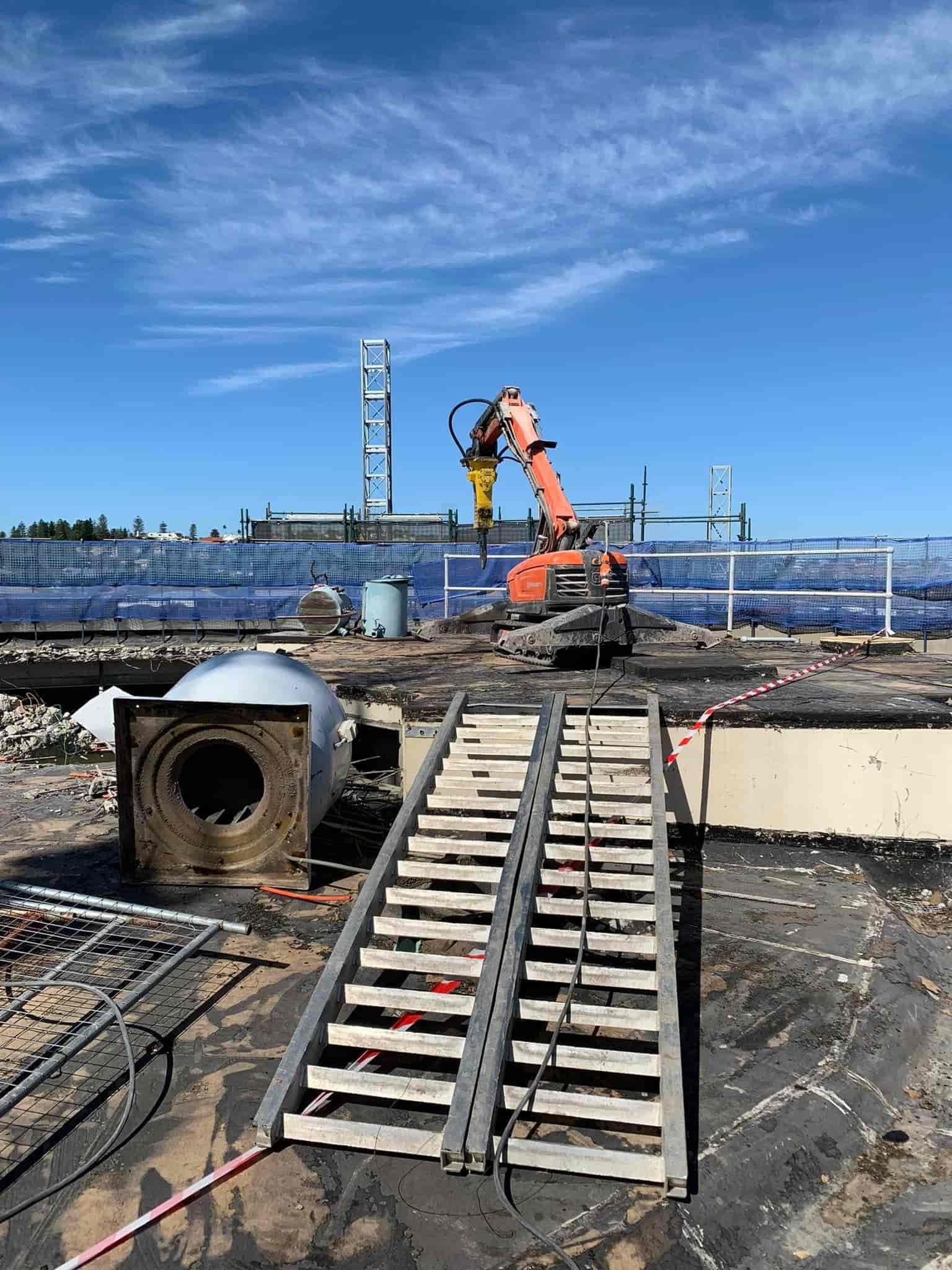 A construction site with a ramp and a crane in the background. — Newcastle Cut N Drill Pty Ltd In Boolaroo, NSW