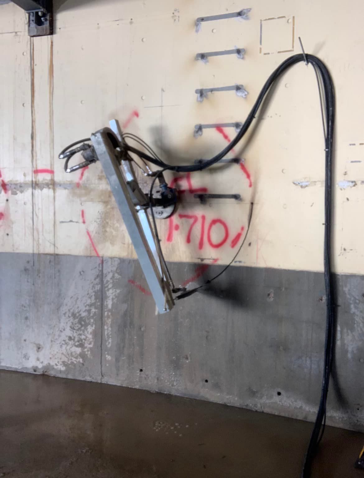 A hose is attached to a wall that says f710 on it — Newcastle Cut N Drill Pty Ltd In Boolaroo, NSW