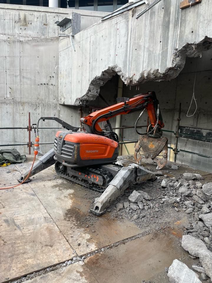 A robot is cutting a hole in a concrete wall. — Newcastle Cut N Drill Pty Ltd In Boolaroo, NSW