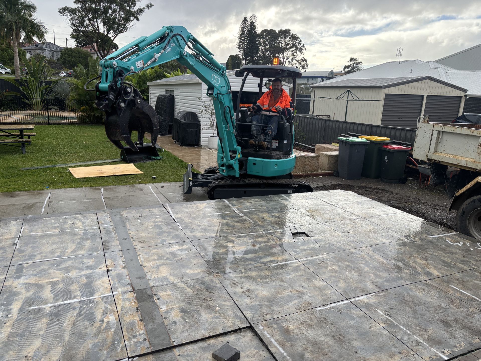 A Man sitting in a cut and remove machine on the top of a concrete slab — Newcastle Cut N Drill Pty Ltd In Boolaroo, NSW