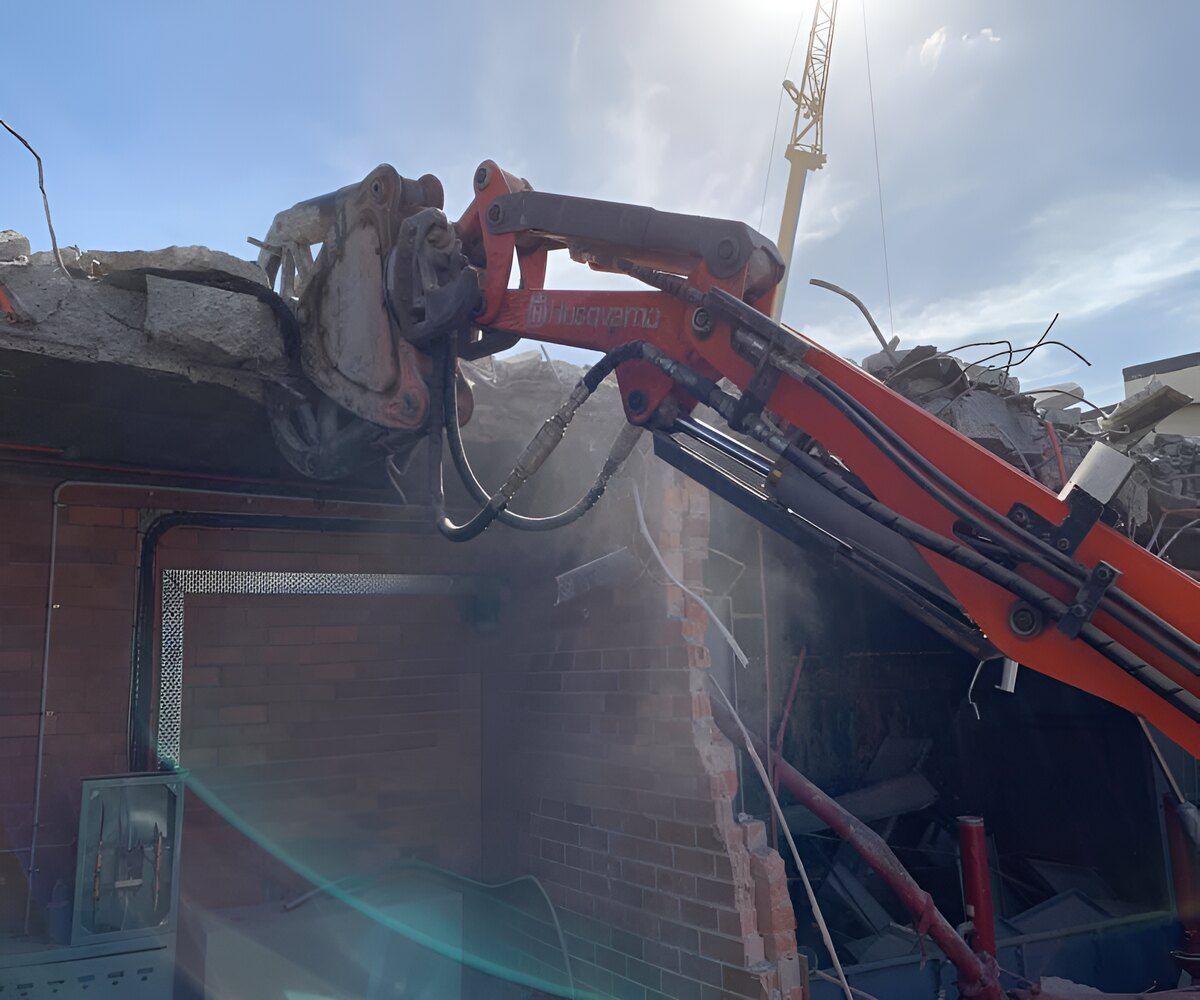 A Machine Is Cutting Through A Brick Wall — Newcastle Cut N Drill Pty Ltd In Boolaroo, NSW