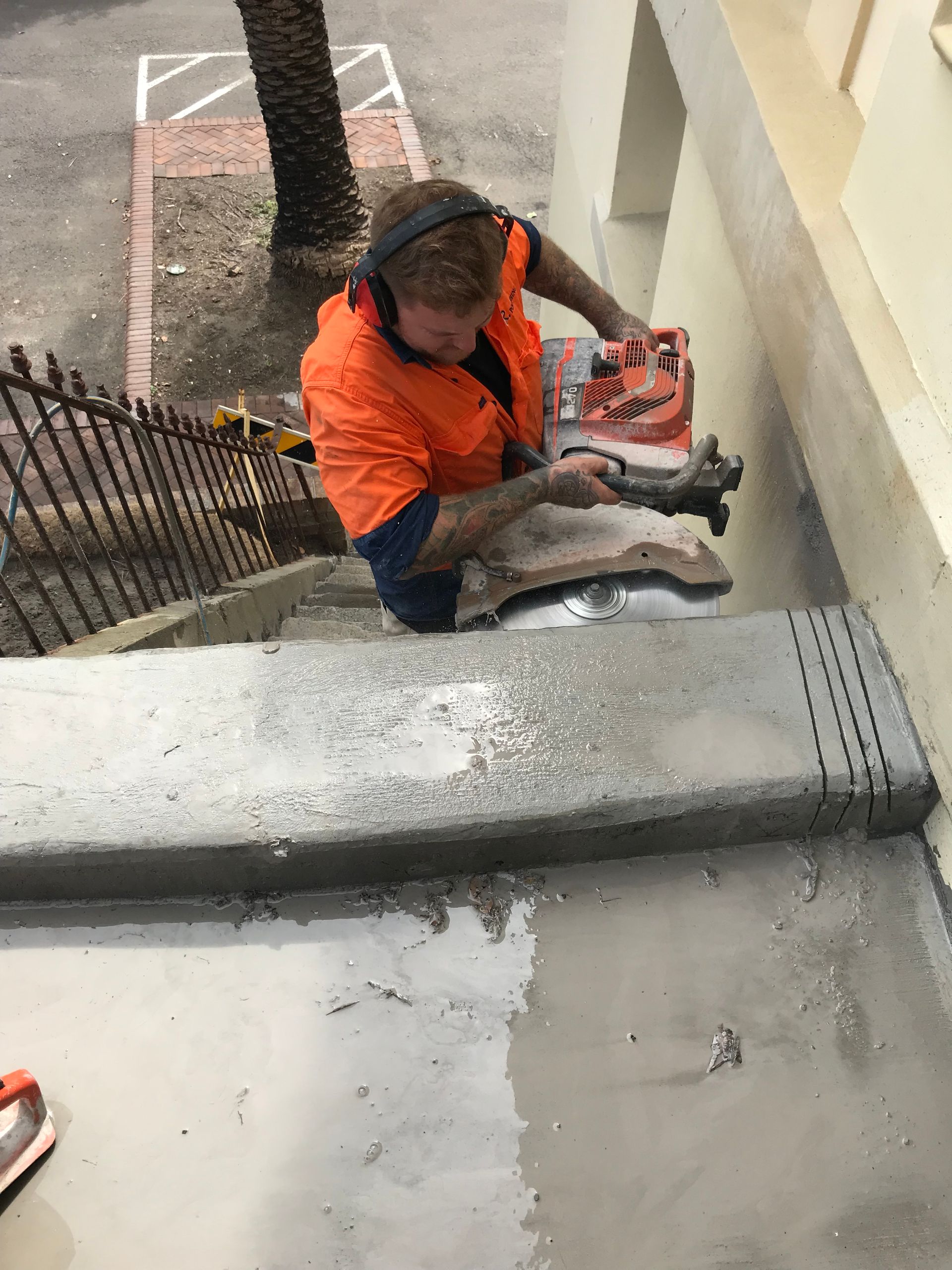 A person is using a circular saw to cut concrete. — Newcastle Cut N Drill Pty Ltd In Boolaroo, NSW
