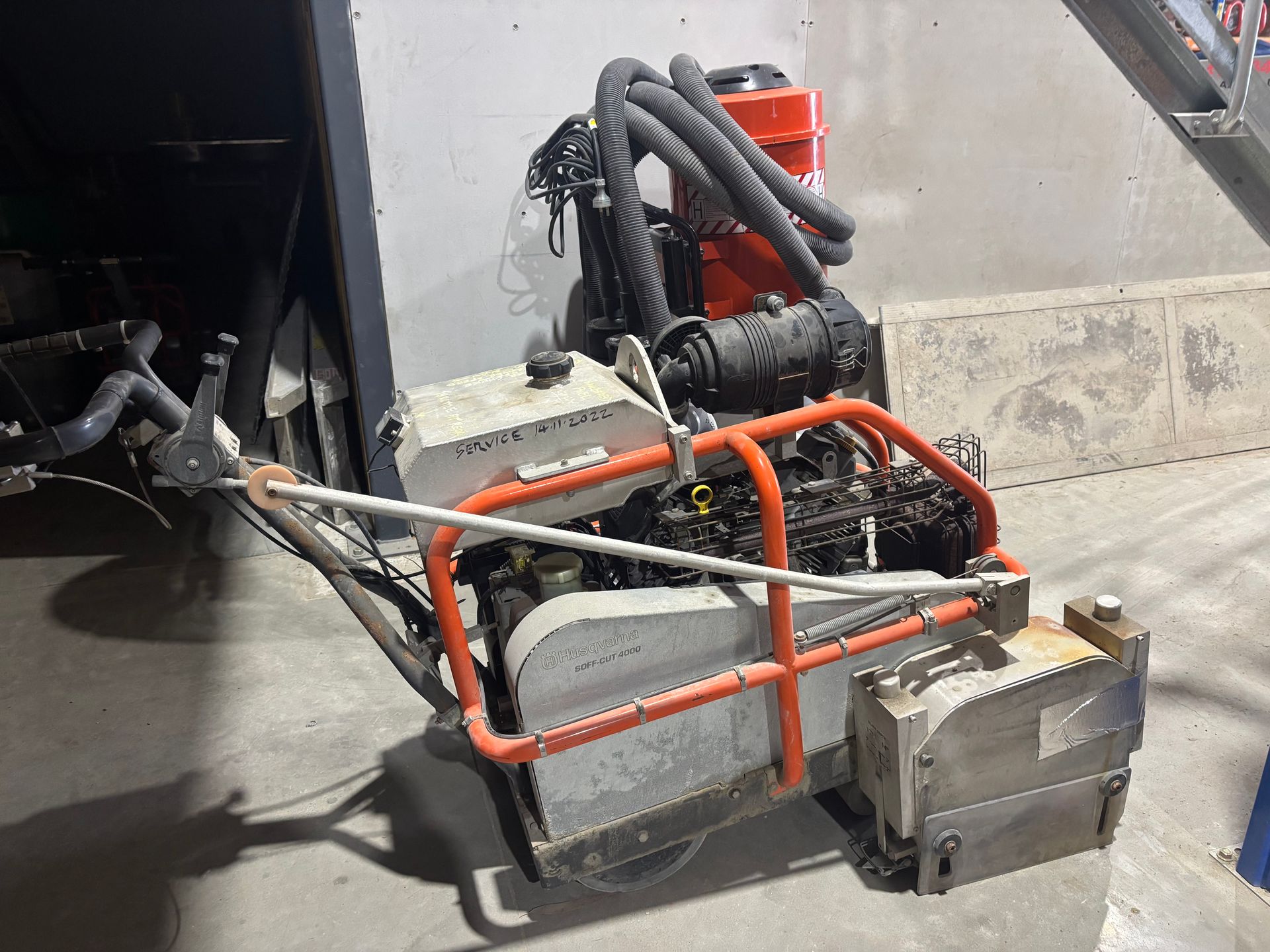 A Concrete Saw Is Cutting A Concrete Floor — Newcastle Cut N Drill Pty Ltd In Boolaroo, NSW