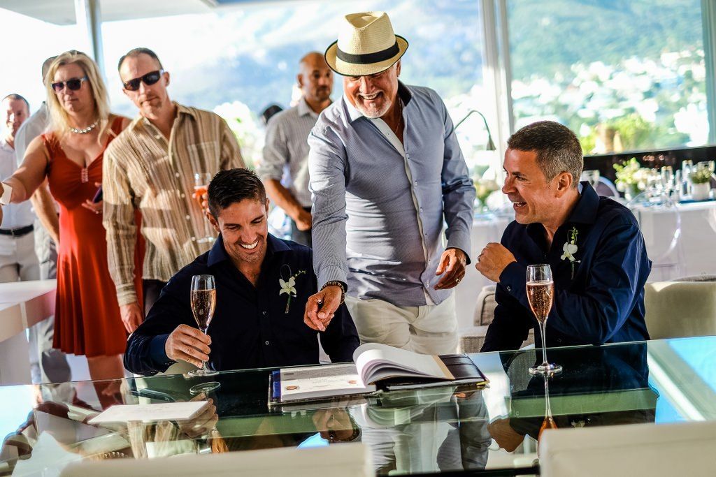 A group of men are sitting at a table drinking champagne.