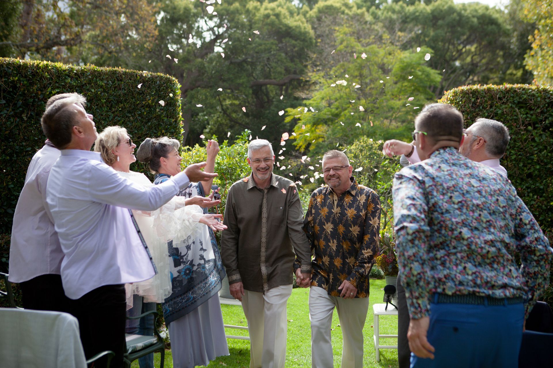 A group of people are throwing confetti at each other.