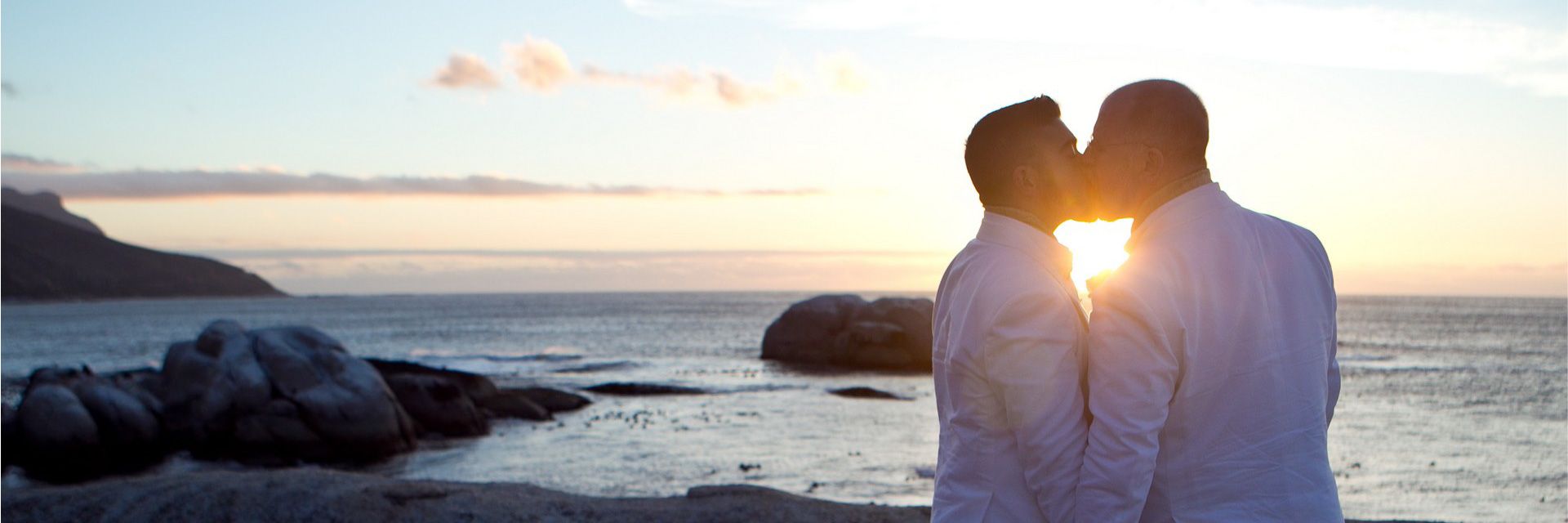 A bride and her bridesmaids are standing next to each other holding bouquets of flowers.