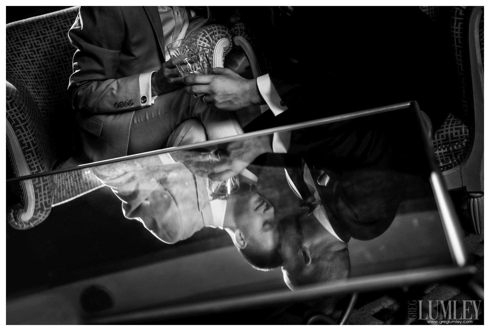A black and white photo of a man and woman sitting next to each other.