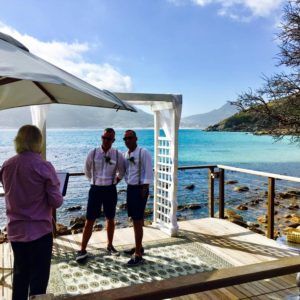 A dining room with tables and chairs and a view of a city.