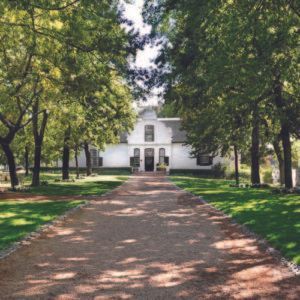 A family posing for a picture while sitting on a rock