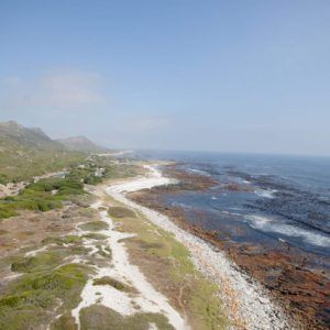 A bride and groom are getting married on top of a mountain