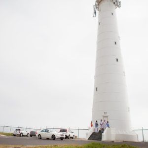 A bride and groom are getting married on top of a mountain