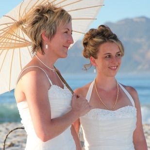 A bride and groom are looking into each other 's eyes on their wedding day.