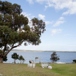 A boat is floating on top of a body of water with mountains in the background.