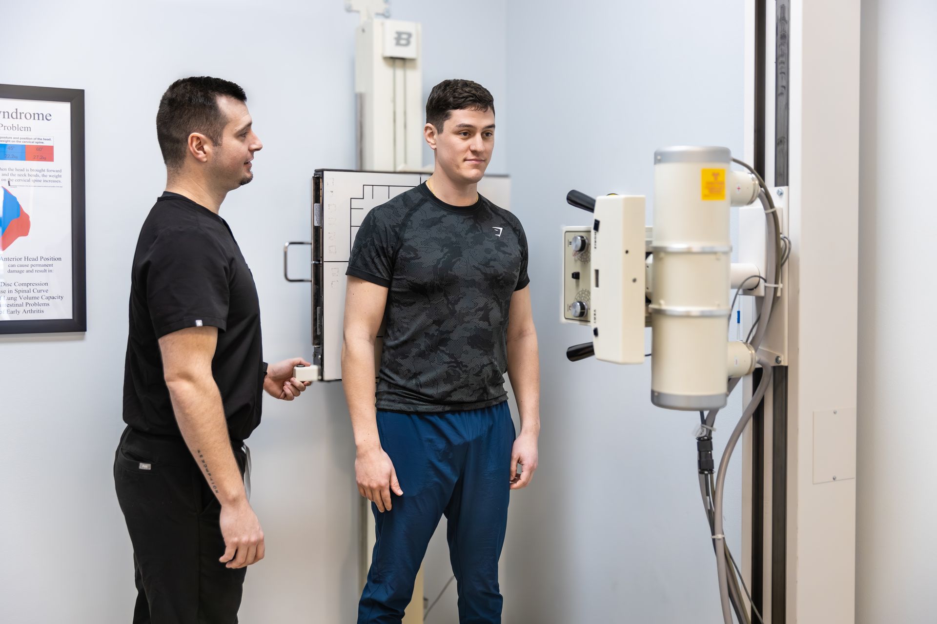 Doctor taking a patient's blood pressure in a medical office; both are smiling.