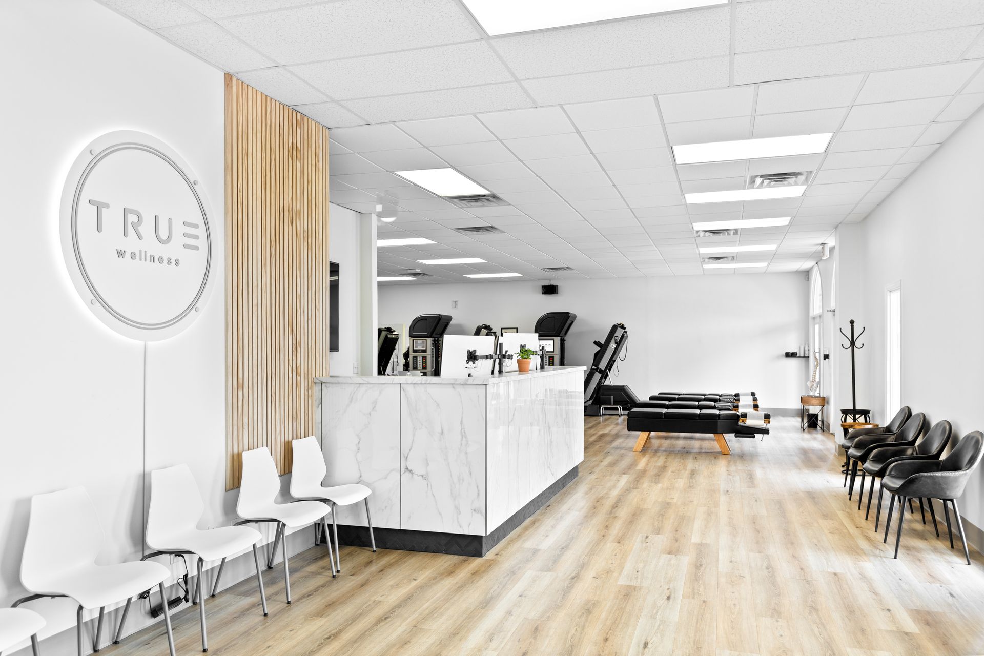 A waiting room with chairs and a counter in a gym.