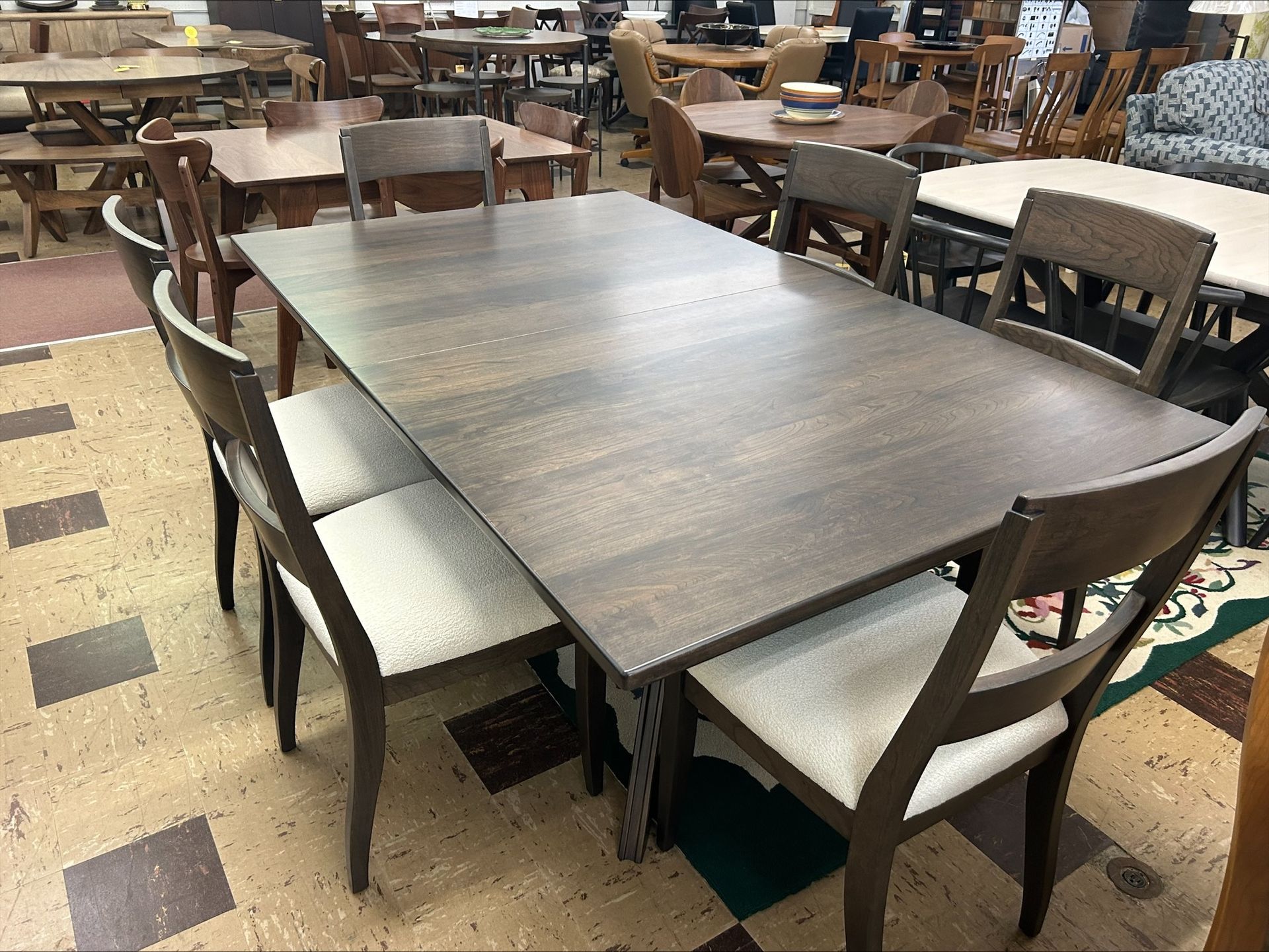 Dining table with six chairs, in a furniture store.