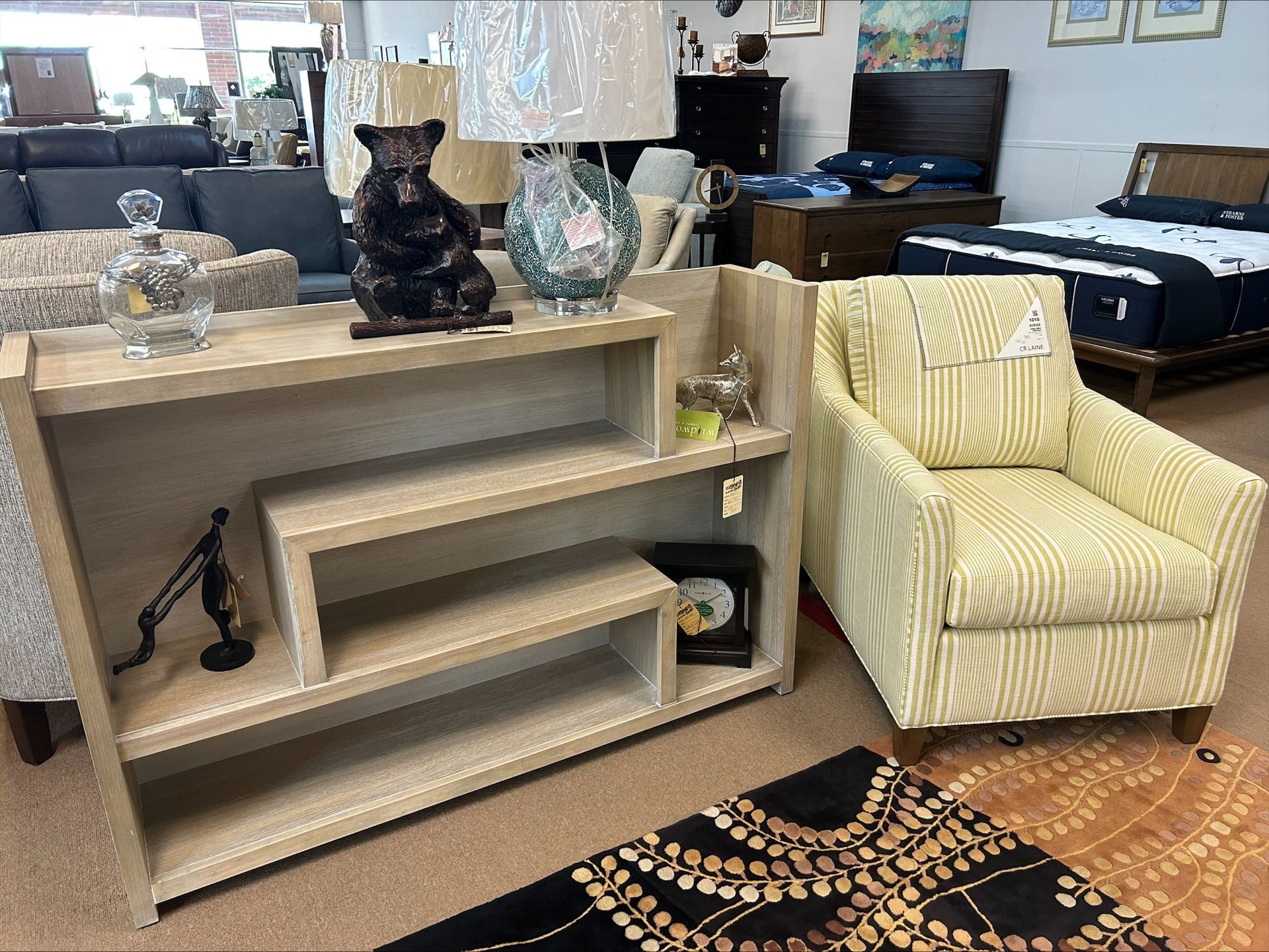 A living room filled with furniture including a chair and a shelf.