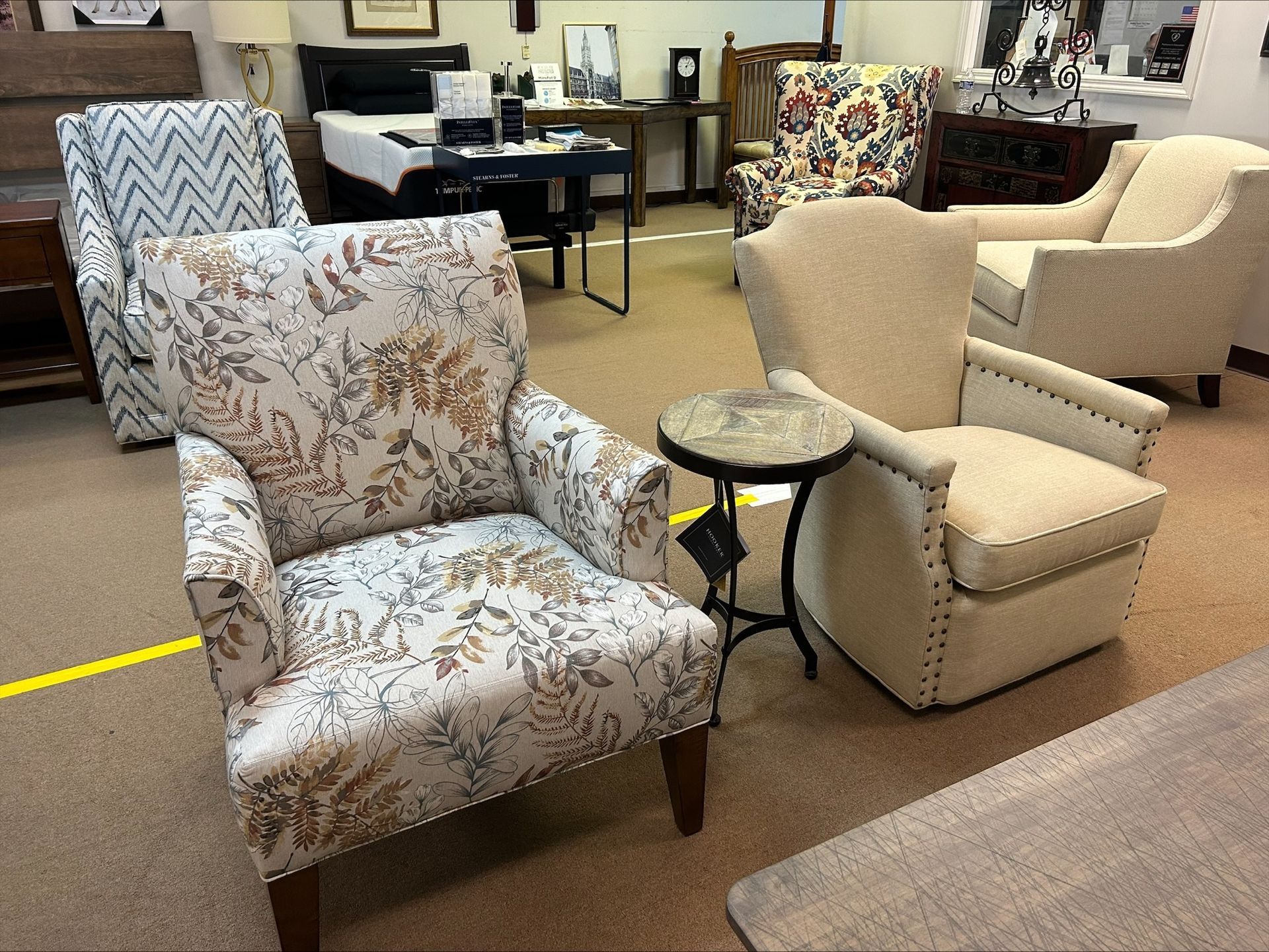 A living room filled with furniture including chairs and a table.