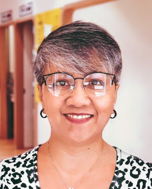 A woman is sitting at a desk working on a project.