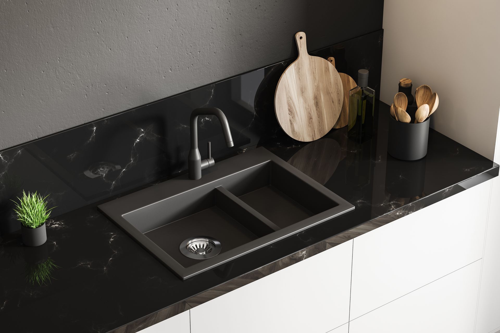 Black kitchen countertop with a double sink, faucet, and accessories.