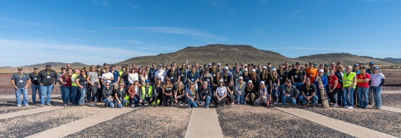 Modern white kitchen with marble countertops, stainless steel appliances, and built-in lighting.