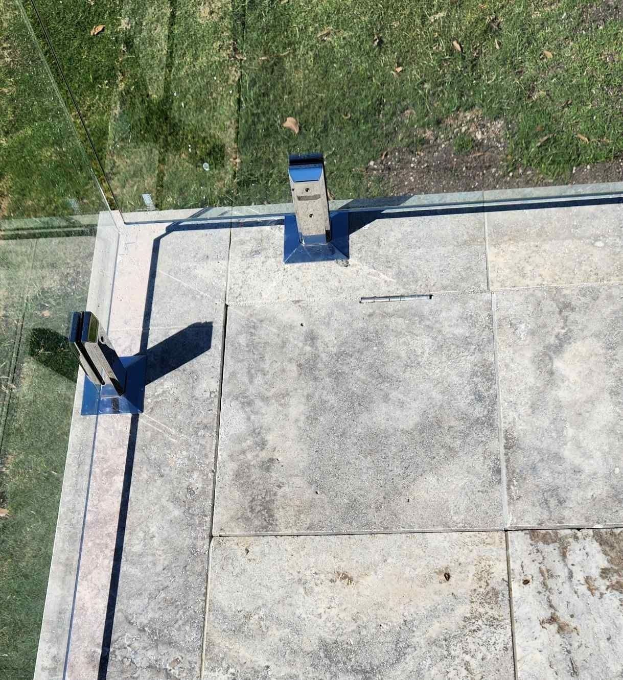 Overhead view of a flat rooftop with a chimney. The roof appears to be made of stone tiles.
