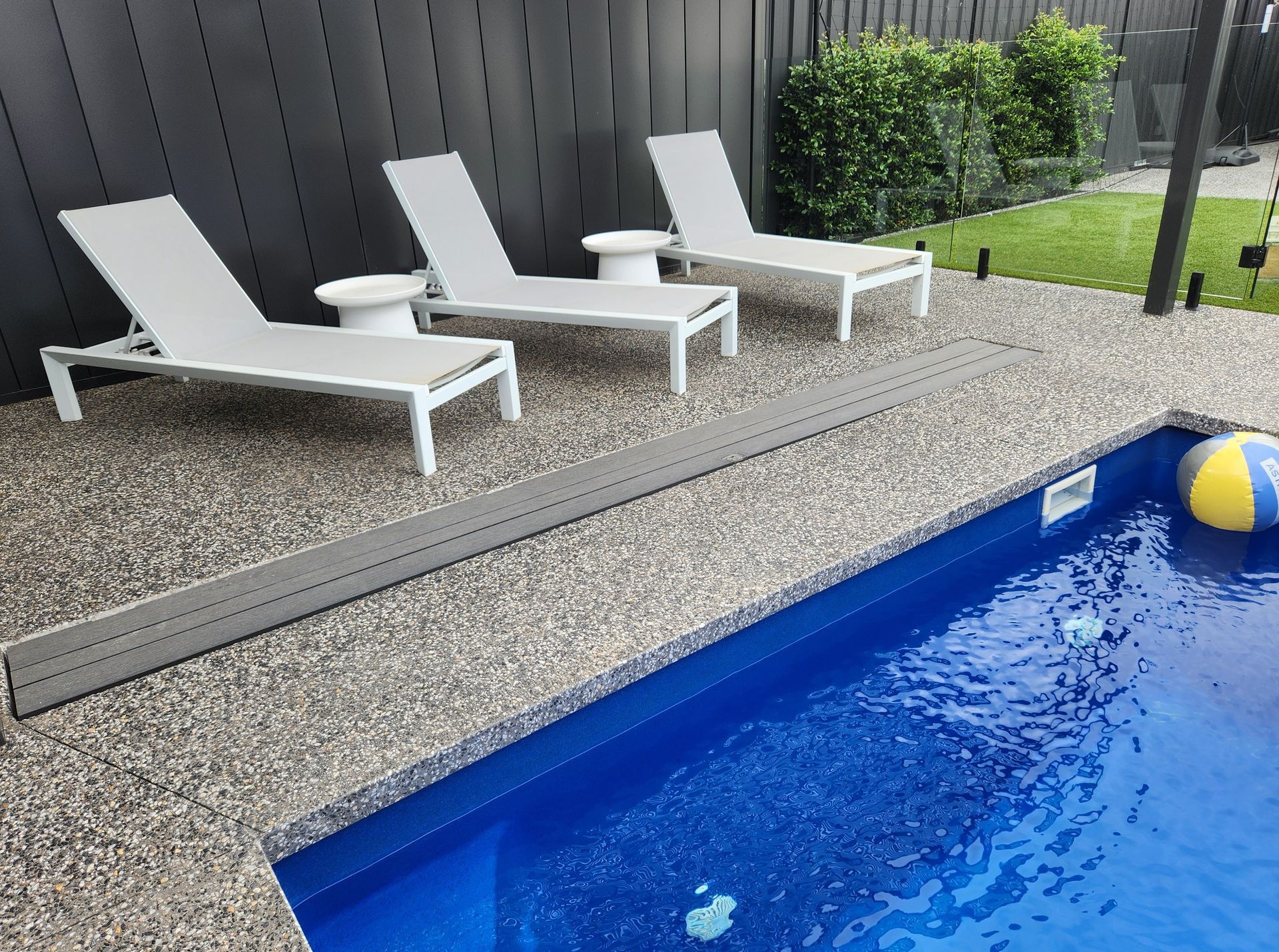 Opened rectangular metal access door in stone patio revealing mechanical components.