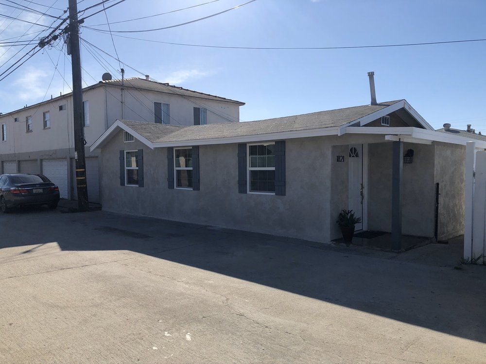 A house with a car parked in front of it
