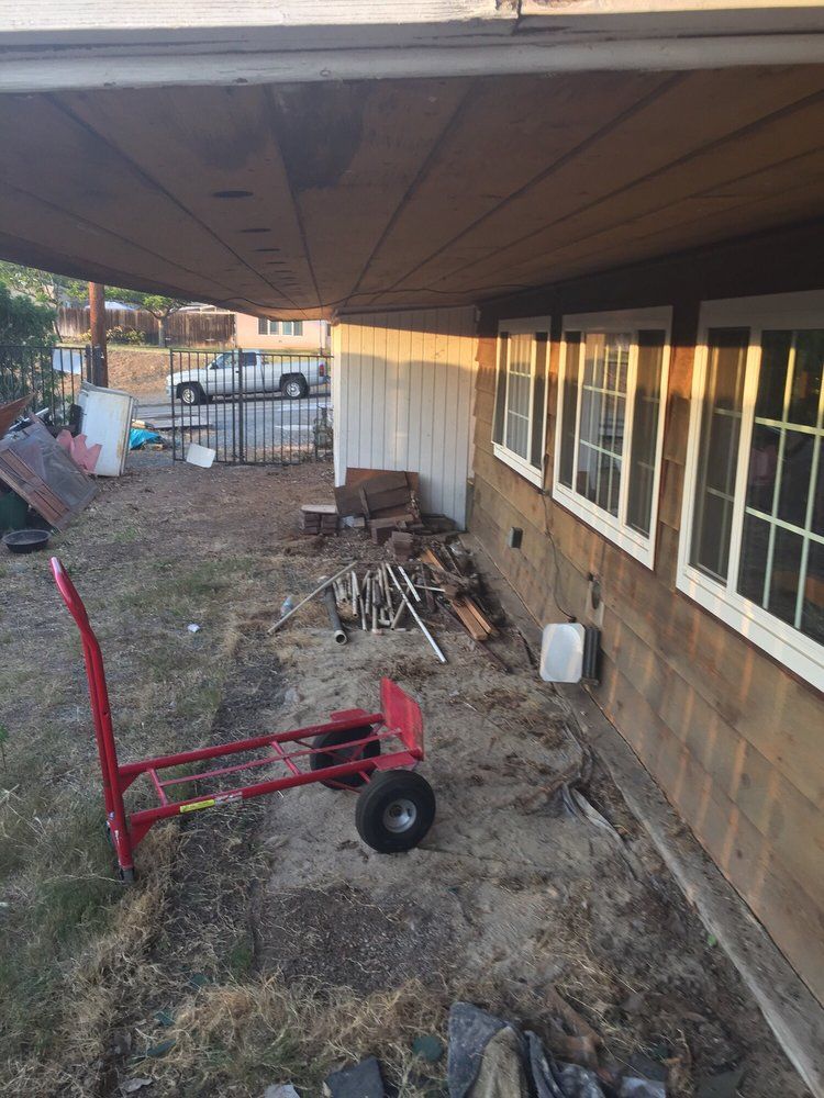 A red cart is parked in front of a house.