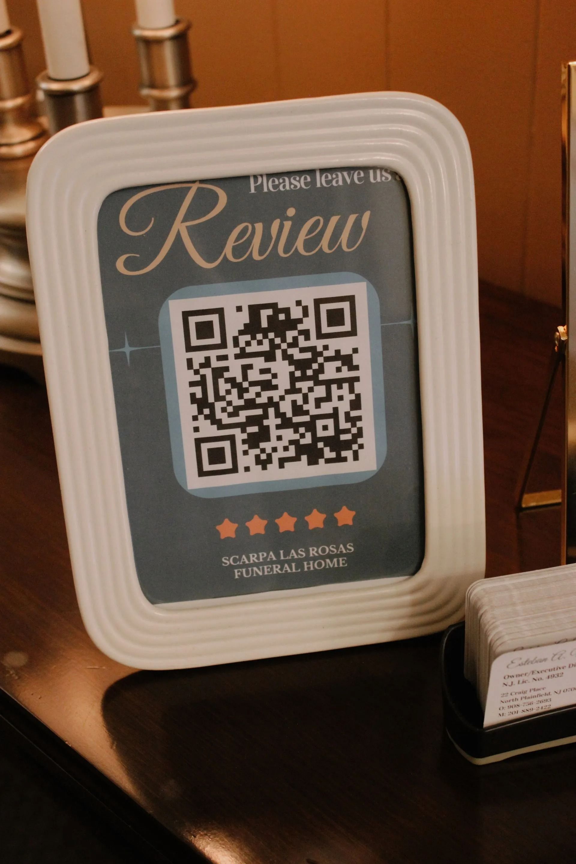 A framed sign requesting reviews for 