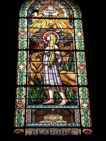 Full stained glass window of Saint Blandina with a lion, Lyon church