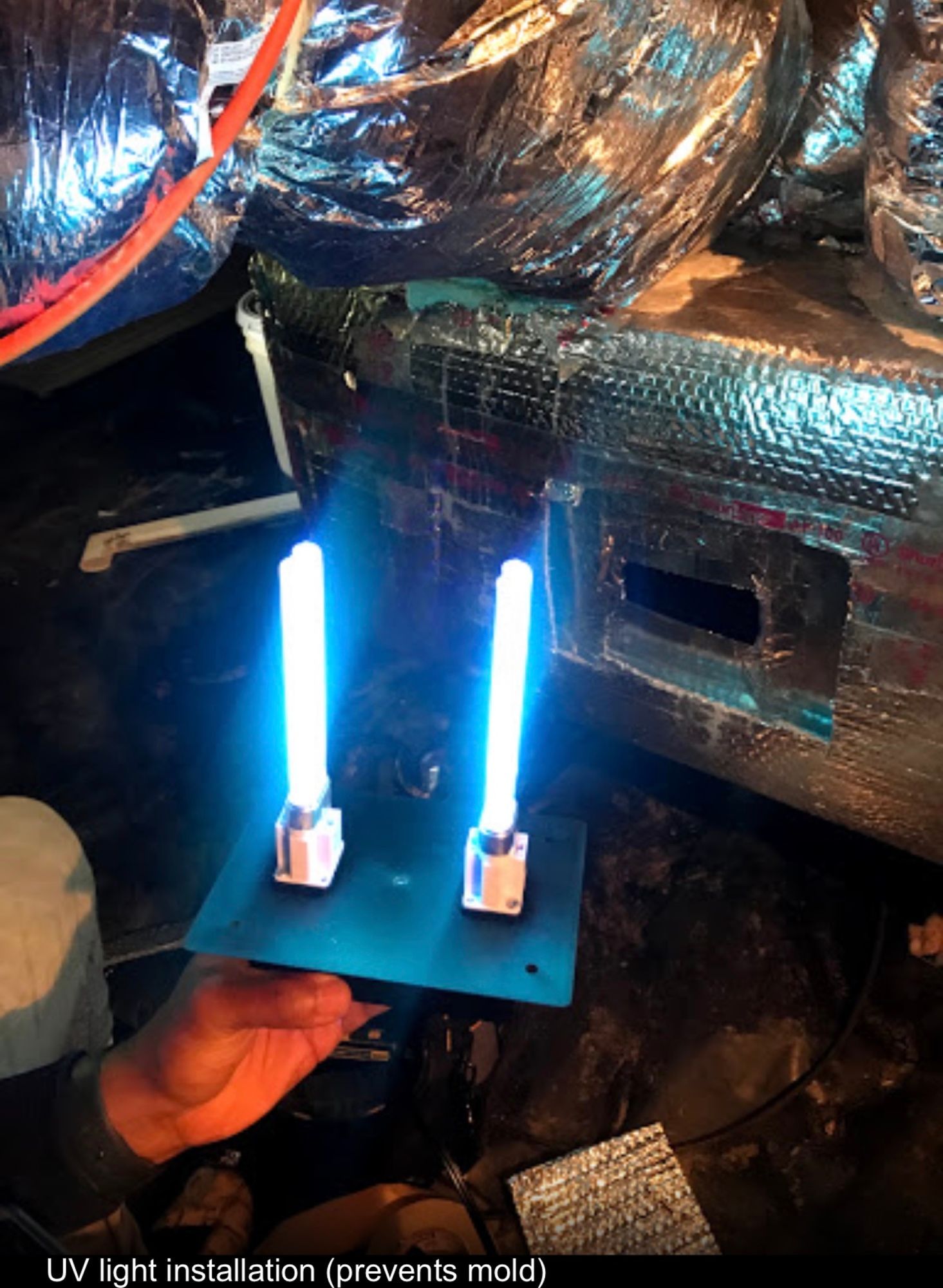 A person is holding two uv lights in their hand.